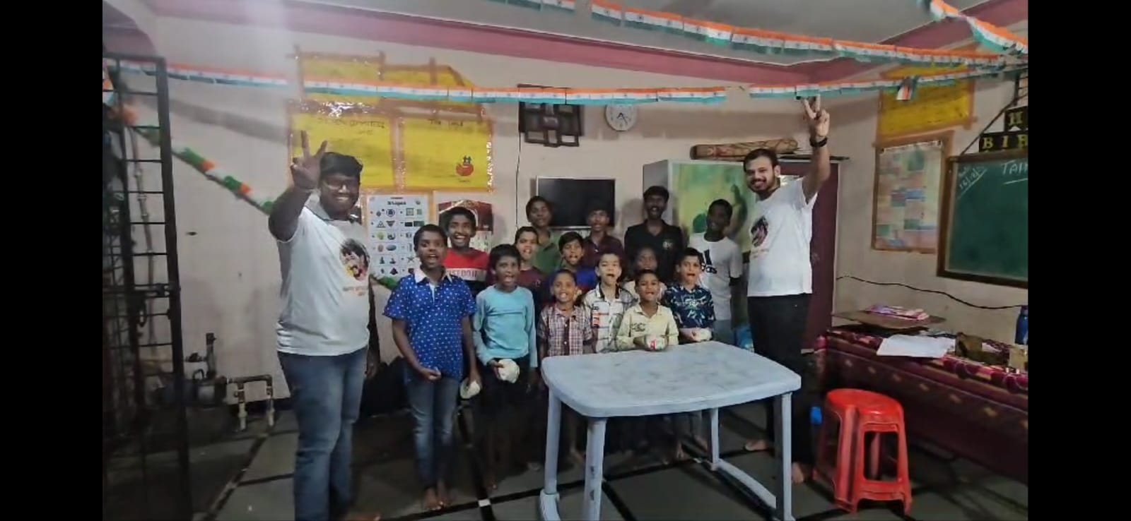 Vineel Anna birthday celebration with community children at orphanage, sharing Scrumptious burgers